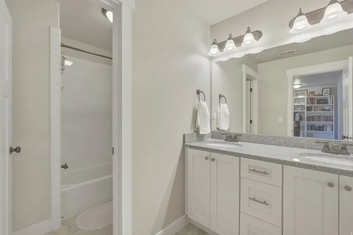 Full bath with double vanity and bathing tub / shower combination