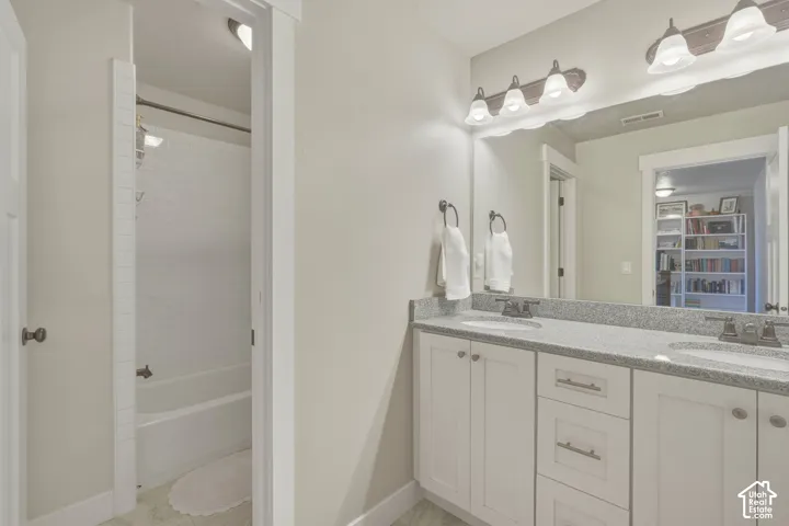 Full bath with double vanity and bathing tub / shower combination