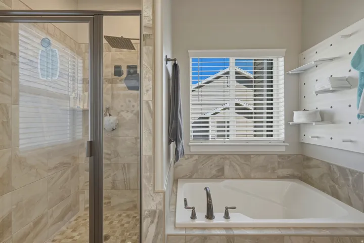 Bathroom with a stall shower and a bath