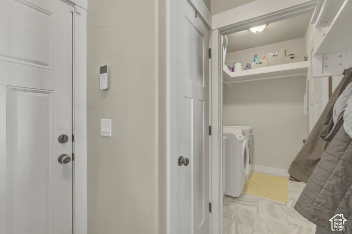 Laundry area featuring washer and clothes dryer and baseboards