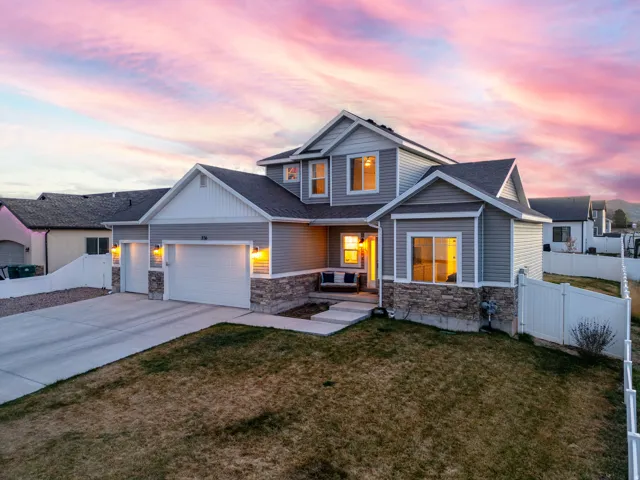Modern two-story residence featuring gray siding and stone accents