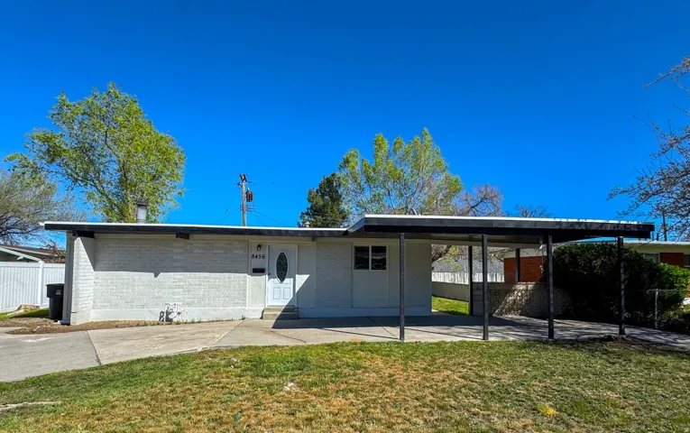 View of front of home with brick siding and an attached carport