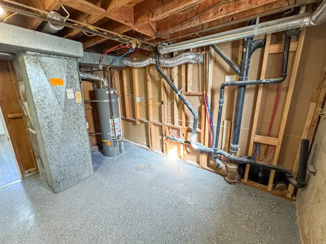 Unfinished basement with strapped water heater and heating unit