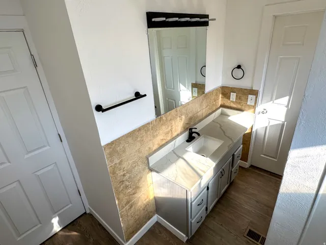 Bathroom with vanity and dark wood finished floors