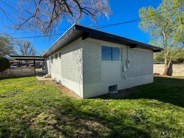 View of home's exterior with a yard and brick siding