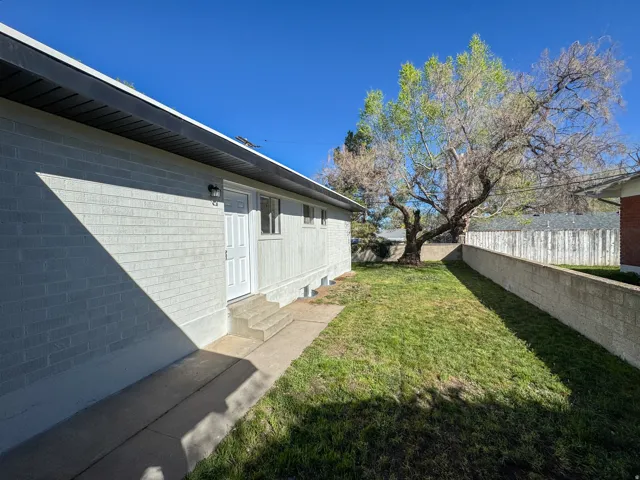 Fenced backyard with entry steps