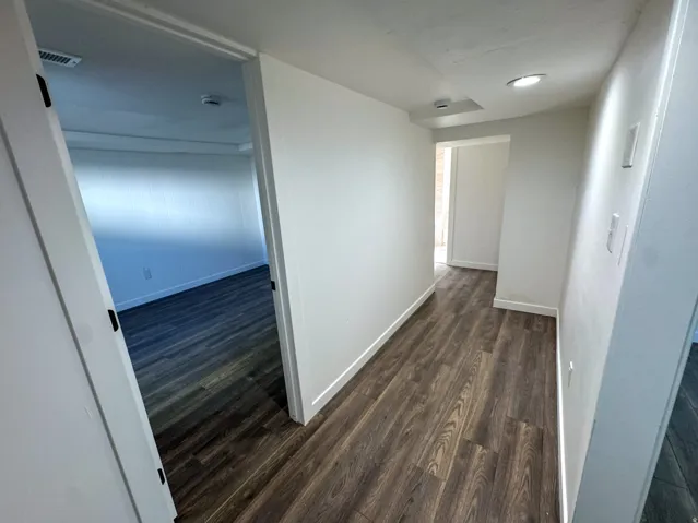 Corridor featuring dark wood-style floors and recessed lighting