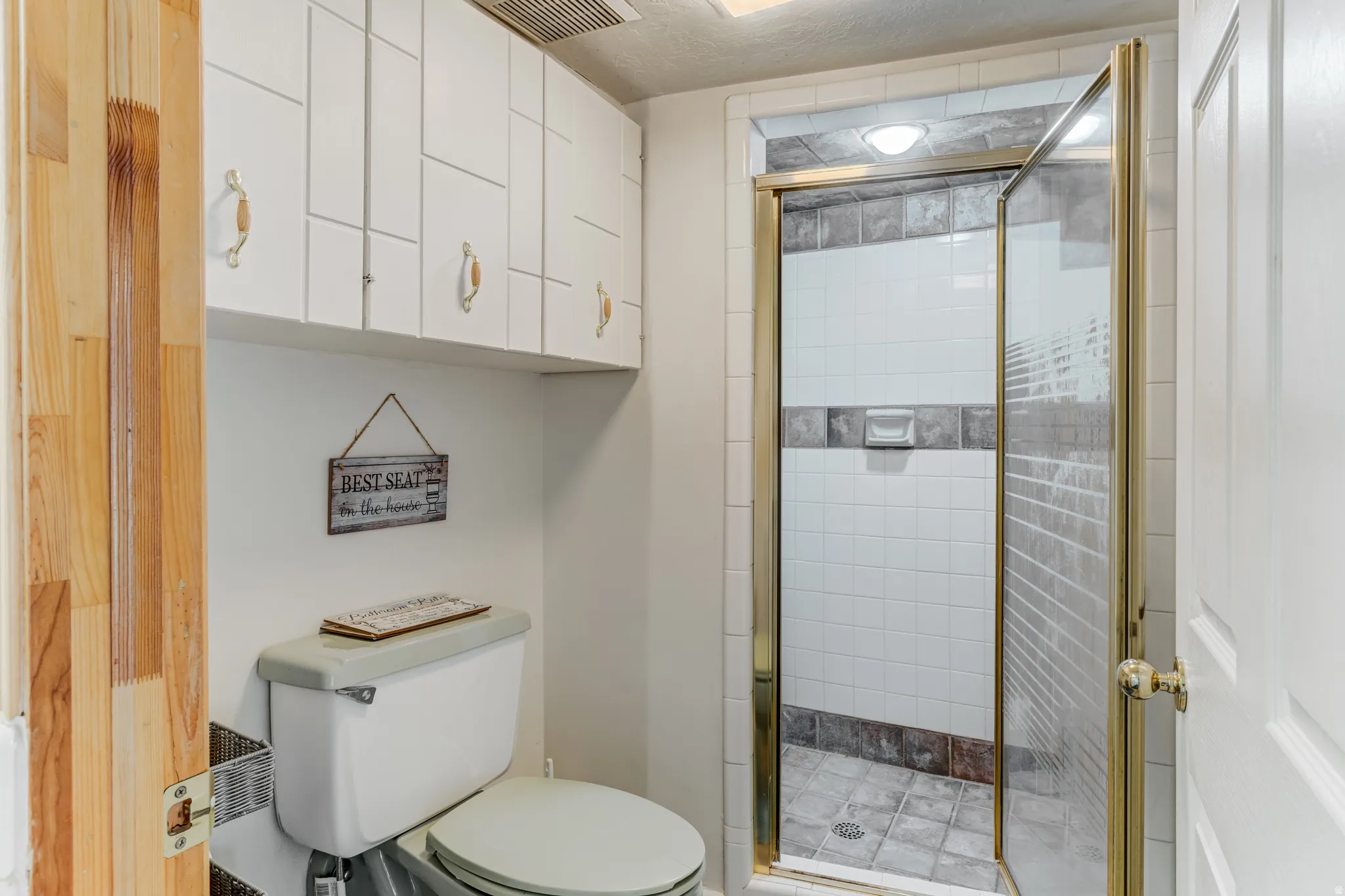 Bathroom featuring toilet and a shower stall