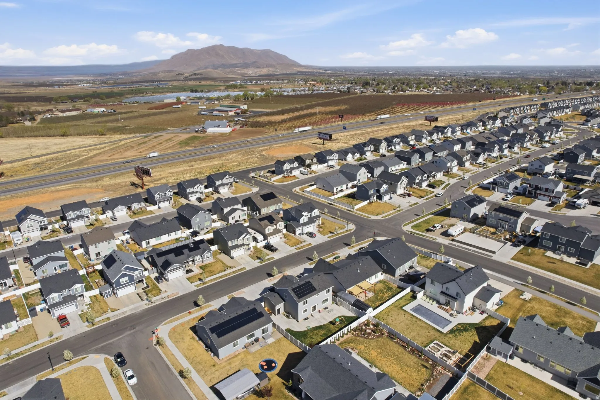 Aerial overview of property's location featuring nearby suburban area and a mountain backdrop