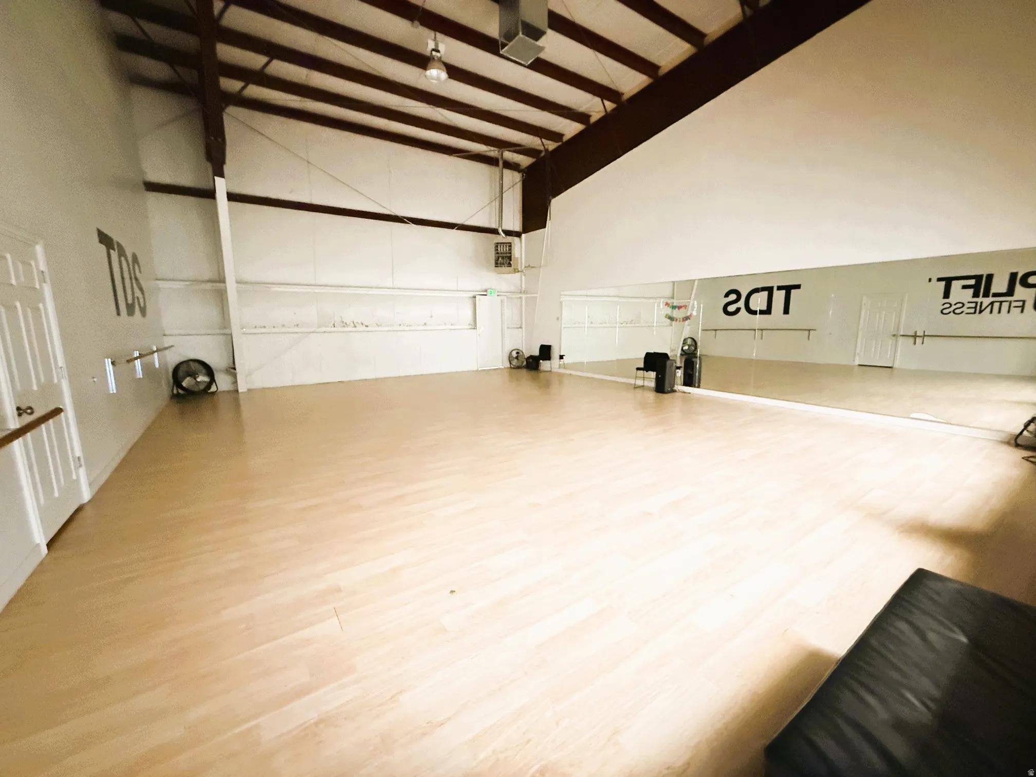 Misc room with lofted ceiling, a garage, and a heating unit