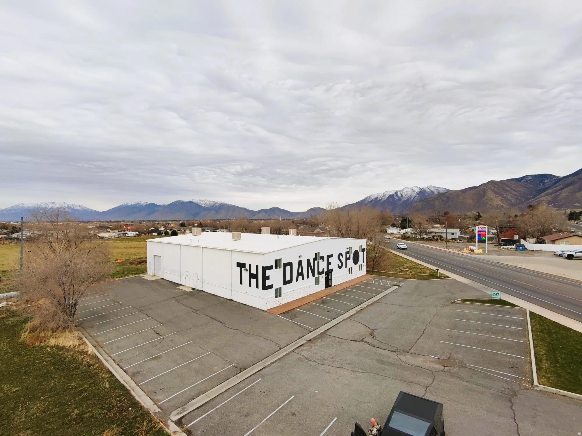 View of property featuring uncovered parking and a mountain view