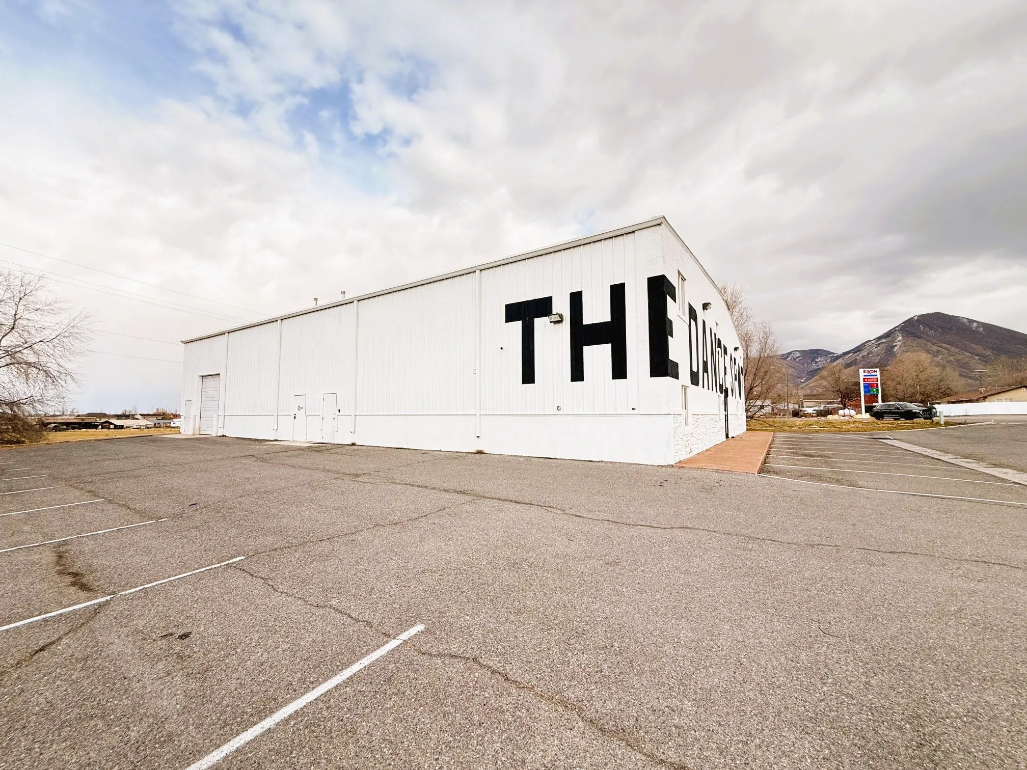 View of property featuring a mountain view and uncovered parking