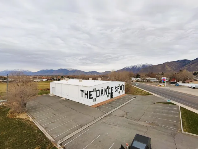 View of property featuring uncovered parking and a mountain view