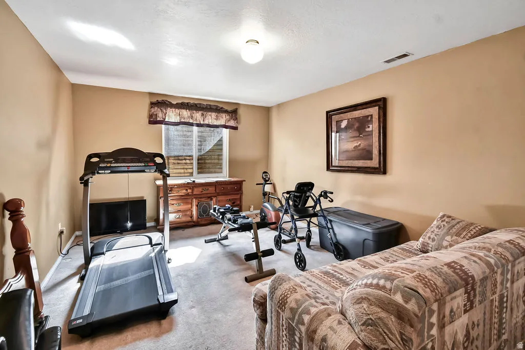 Workout room with carpet and baseboards