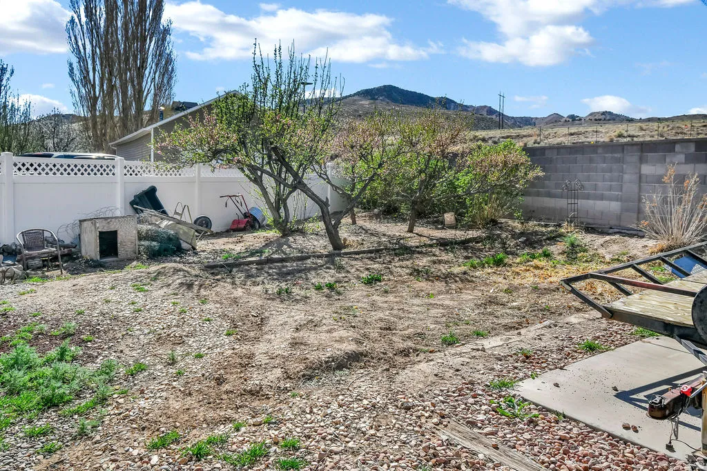 Fenced backyard with a mountain view