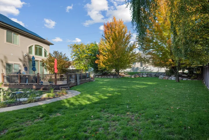 View of yard with a wooden deck