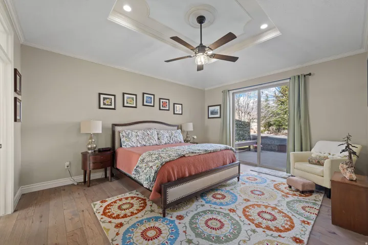 Bedroom featuring light wood-style floors, access to outside, crown molding, and a ceiling fan