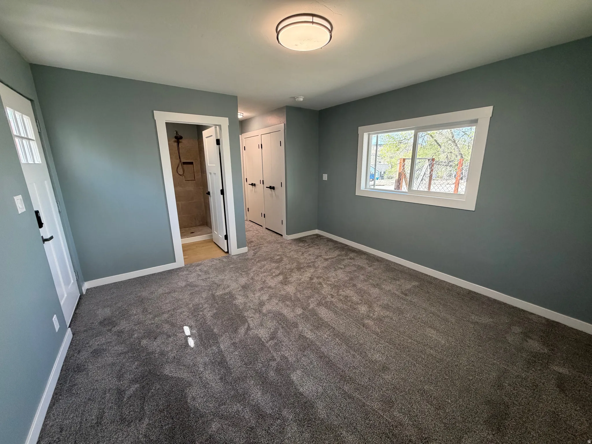 Unfurnished bedroom featuring a closet, carpet flooring, and connected bathroom