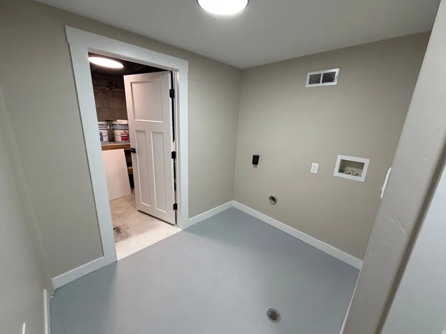 Laundry room with finished concrete floors, washer hookup, and electric dryer hookup