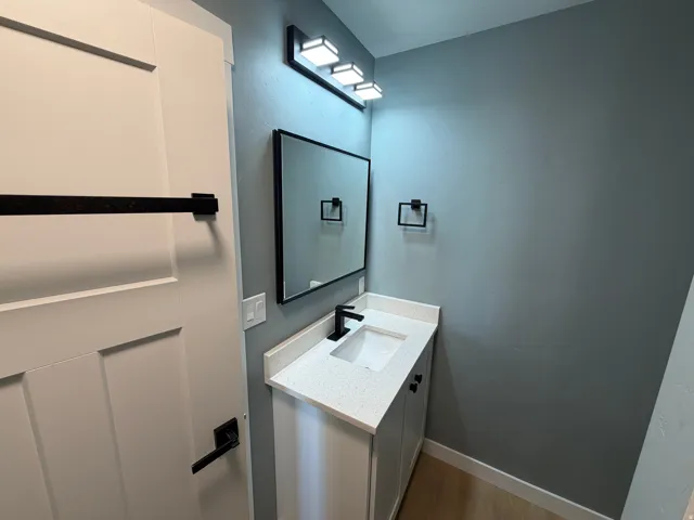 Bathroom featuring vanity and wood finished floors