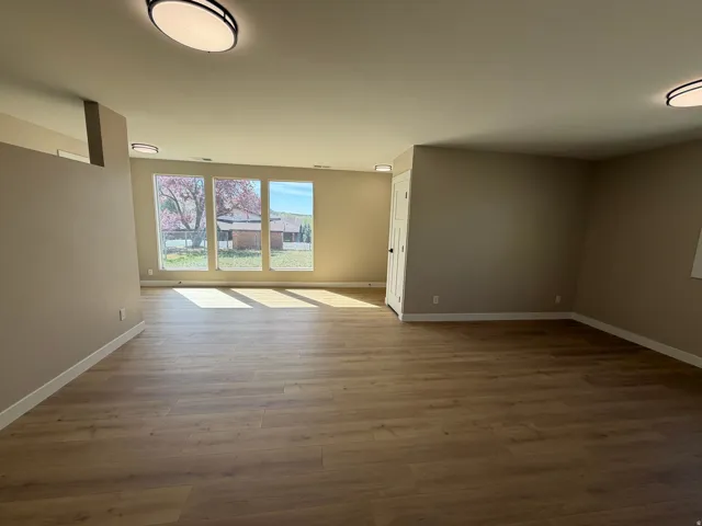 Spare room with light wood-type flooring and baseboards