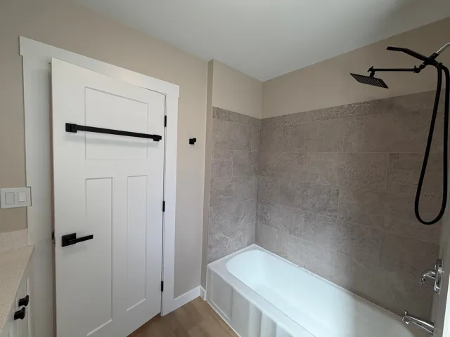 Full bathroom featuring vanity, shower / bathtub combination, and light wood finished floors