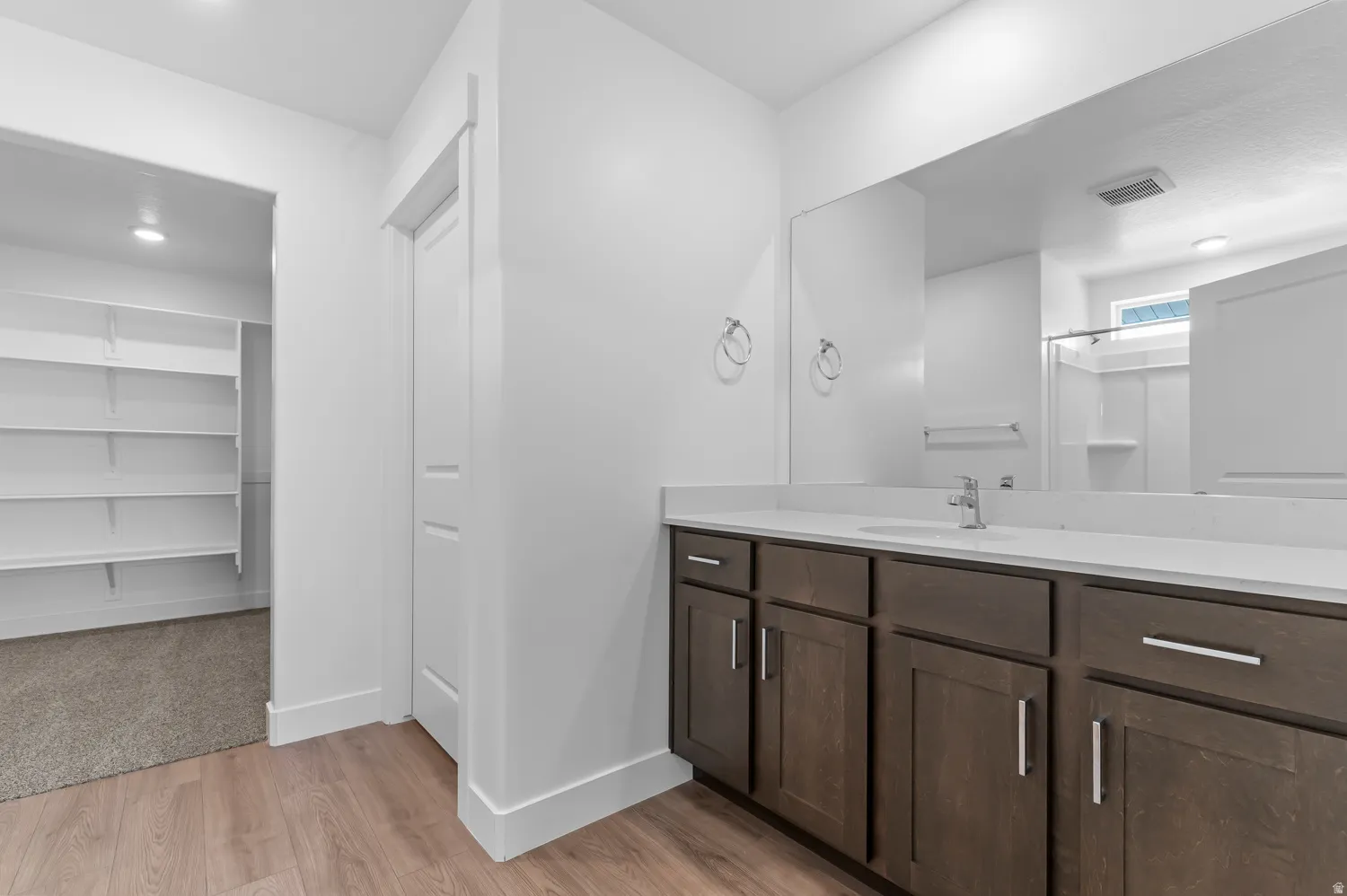 Spacious vanity featuring a single sink and extensive countertop space