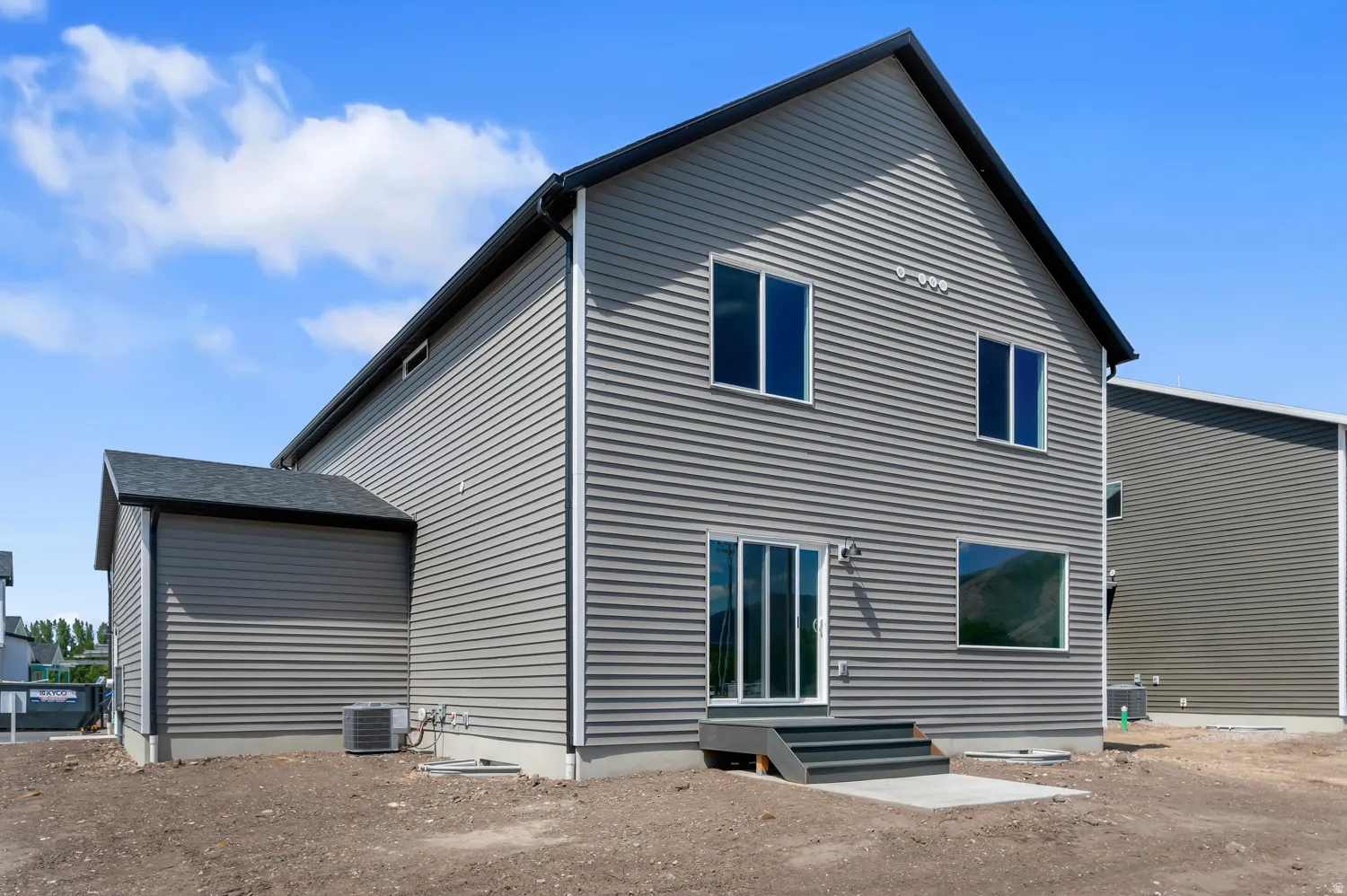 Gray horizontal siding exterior with a black gable roof