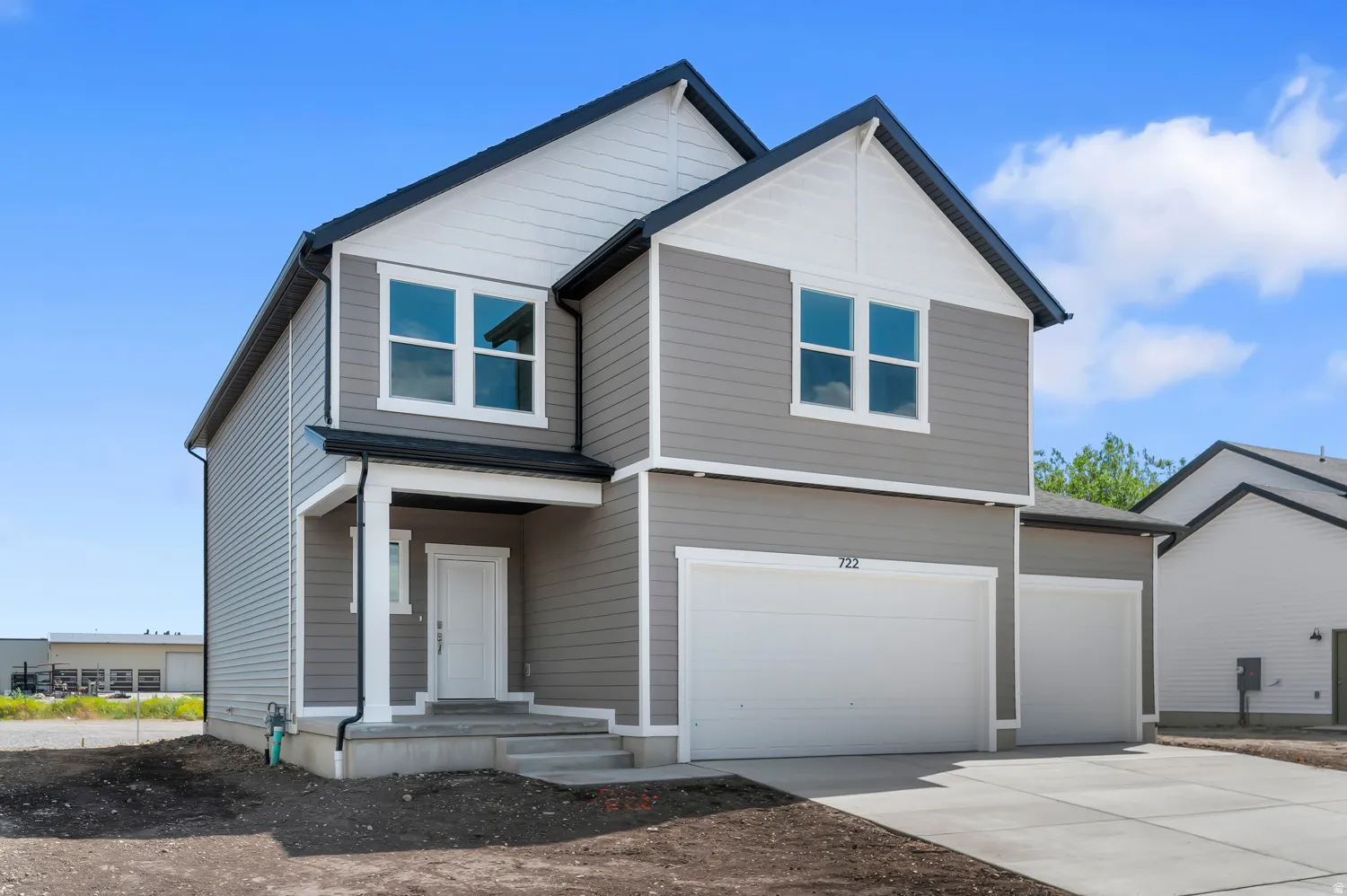 Two-story modern exterior with gray siding and white trim accents