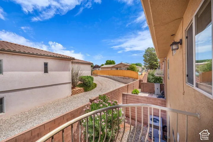 Balcony with metal railing and stucco exterior