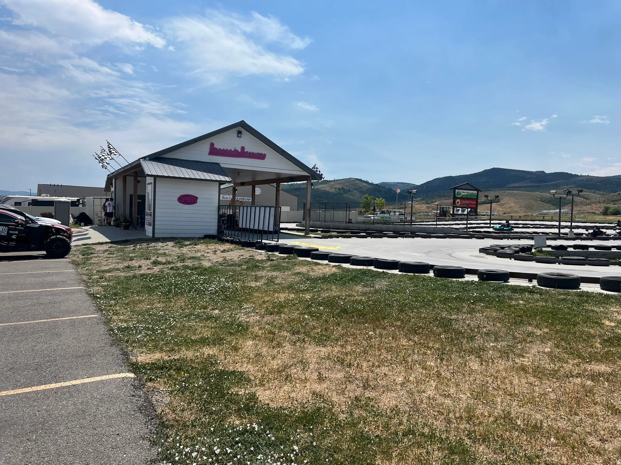 View of building exterior with a mountain view and uncovered parking