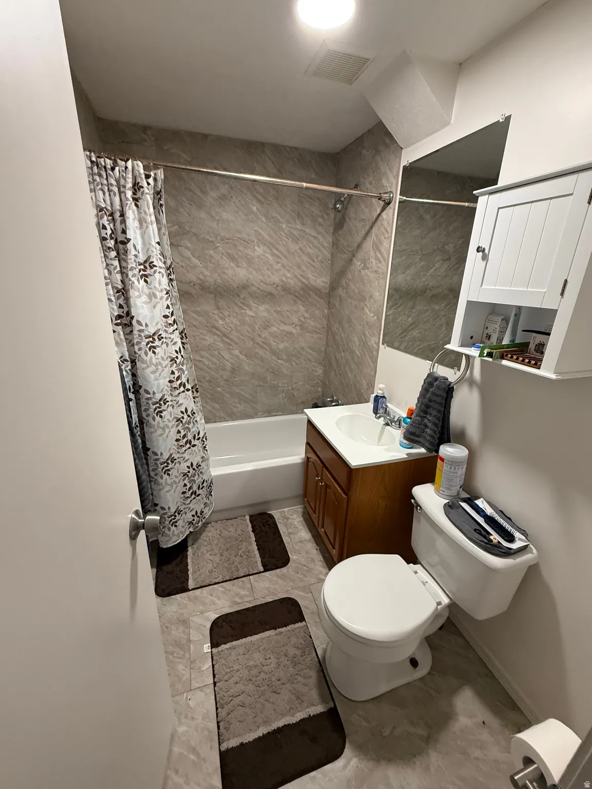Bathroom with vanity and shower / bath combination with curtain