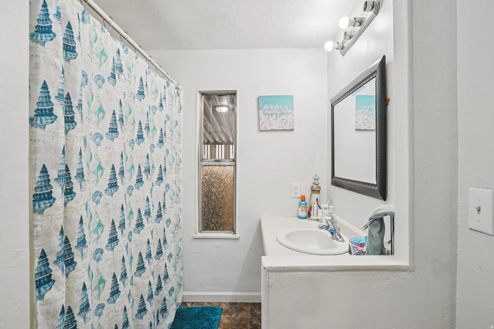 Full bath featuring vanity, a shower with curtain, and a textured ceiling