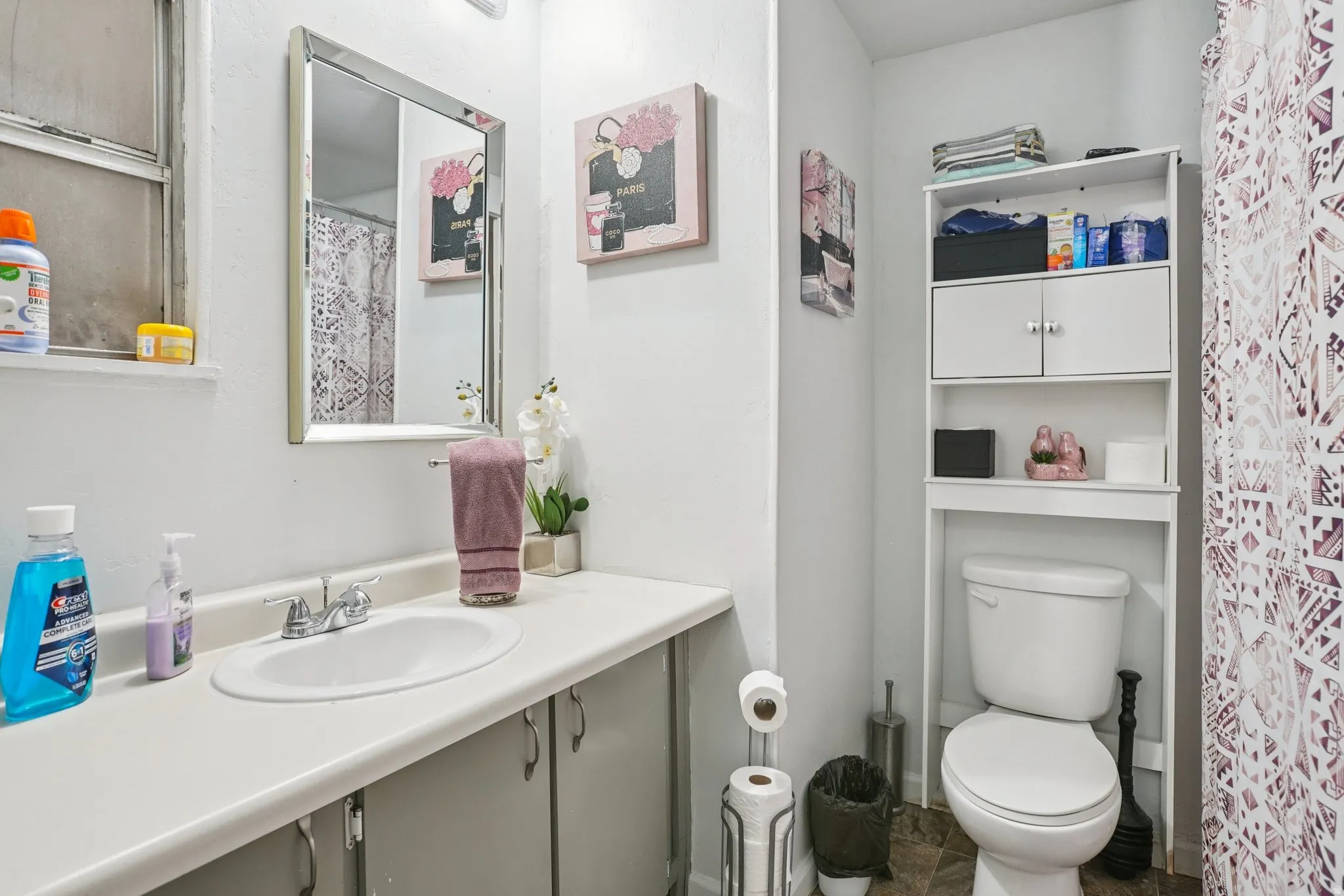 Bathroom with curtained shower and vanity
