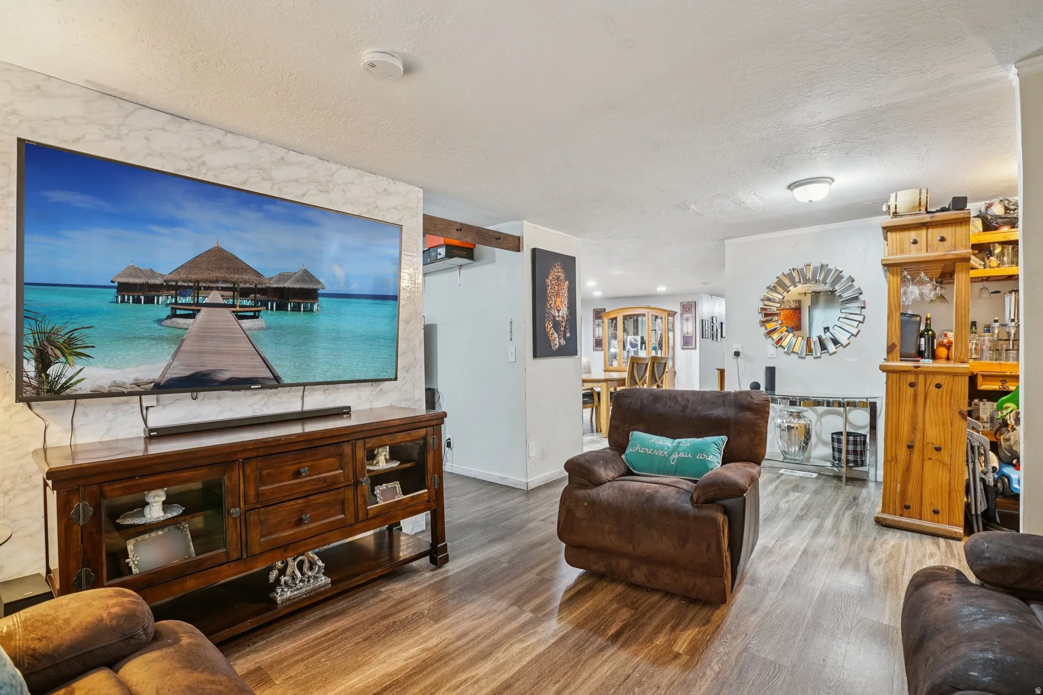 Living room featuring wood finished floors and a textured ceiling