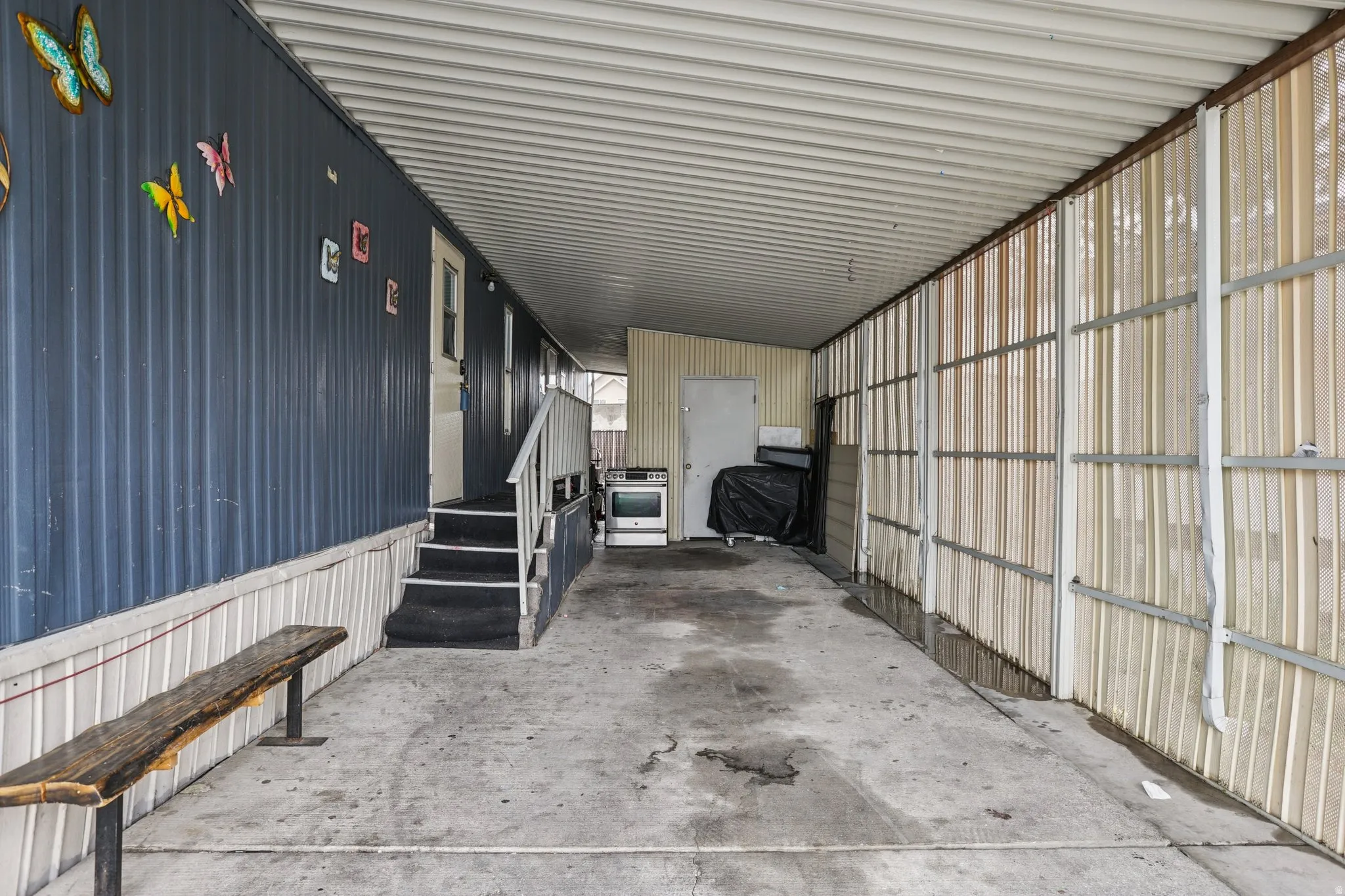 Garage featuring an attached carport