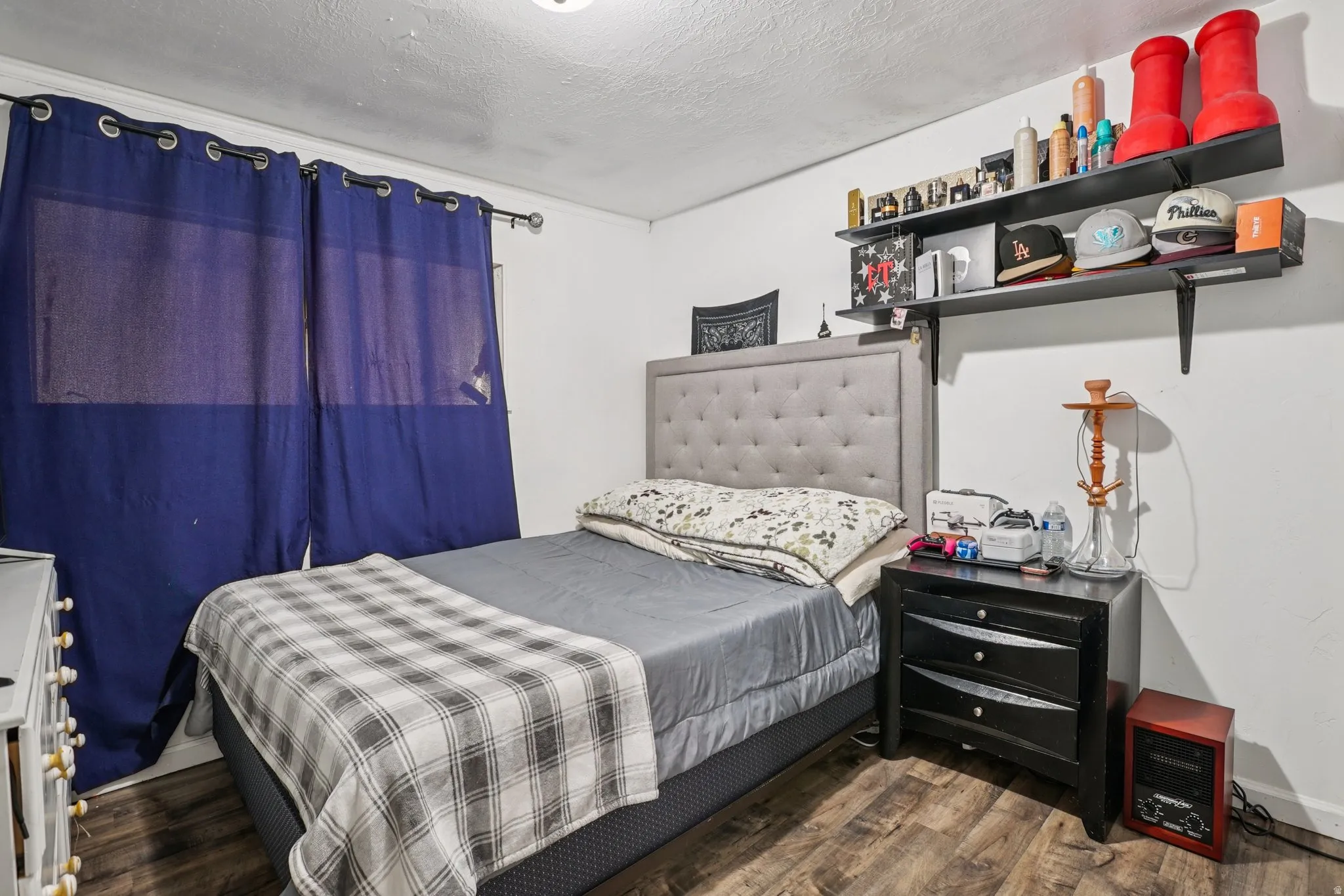 Bedroom featuring dark wood finished floors and a textured ceiling