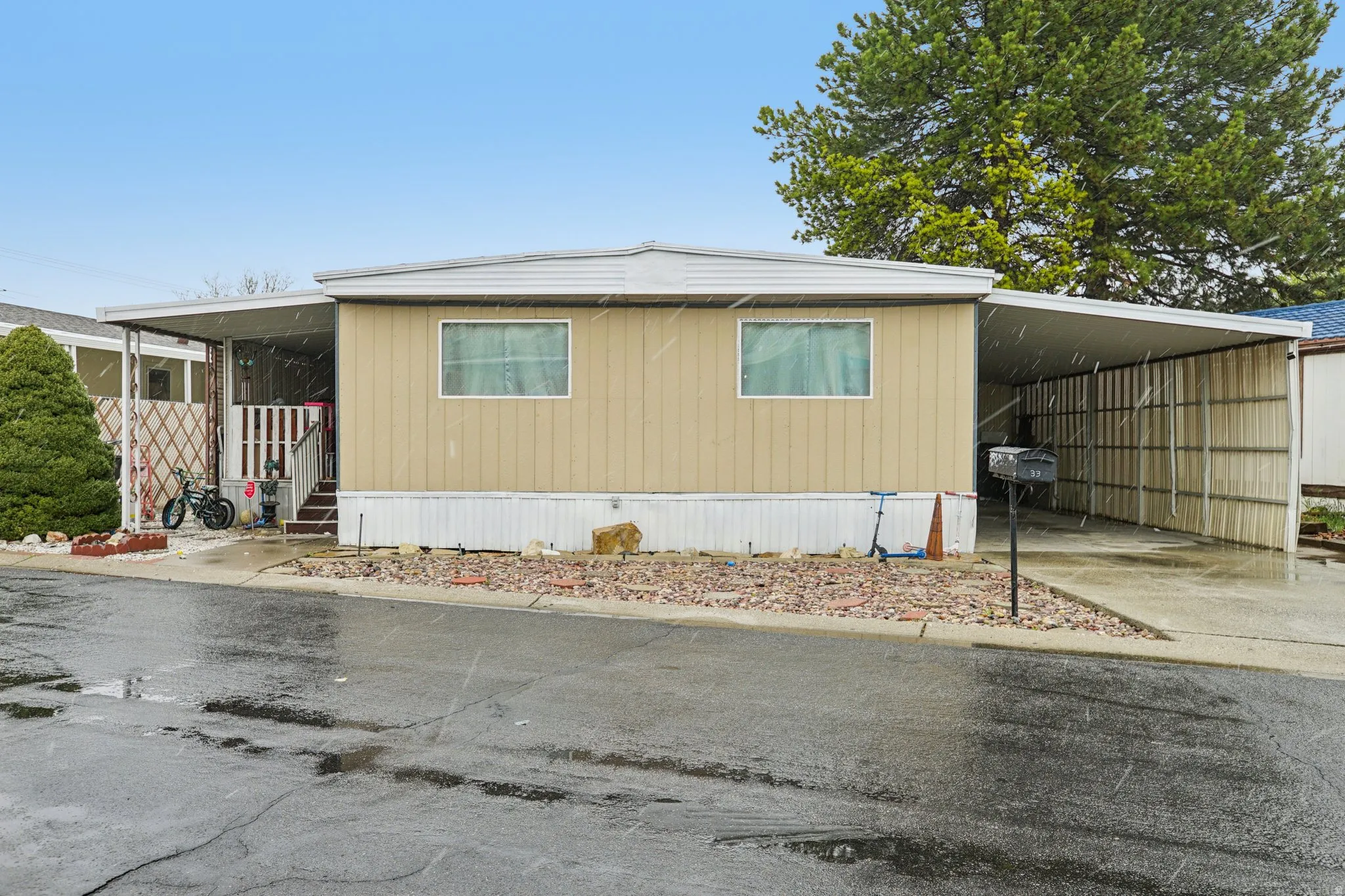 View of front of house with an attached carport and concrete driveway