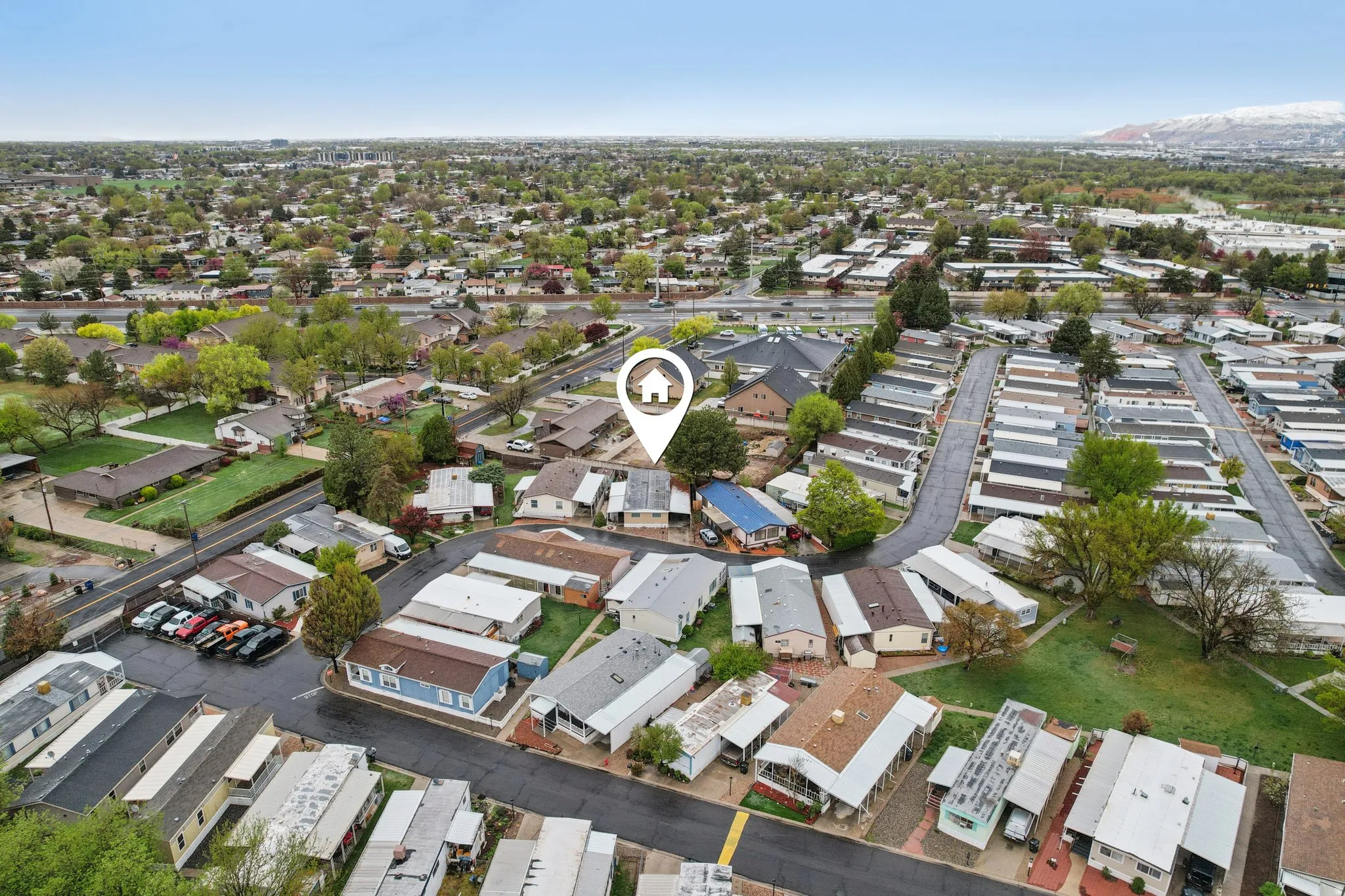 Aerial view of property and surrounding area featuring nearby suburban area
