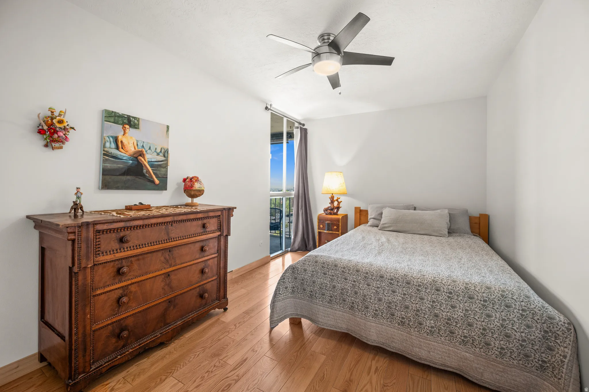 Bedroom featuring light wood finished floors, access to outside, and a ceiling fan