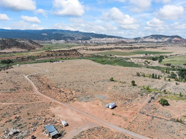 View of rural area with a mountain backdrop and a desert landscape