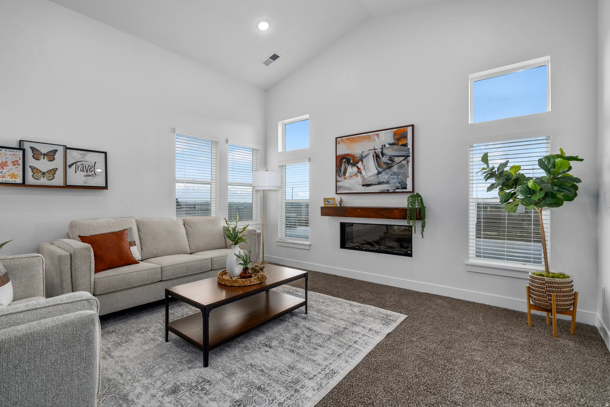 Great room with vaulted ceilings and cozy fire place opens to dining area.