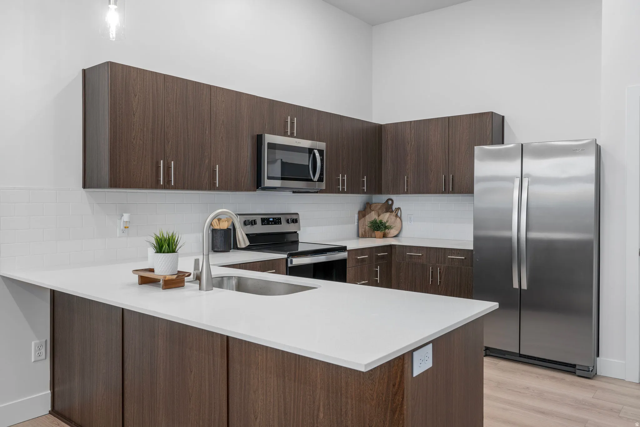 Kitchen with dark wood tone finishes and stainless steel appliances. *fridge not included*