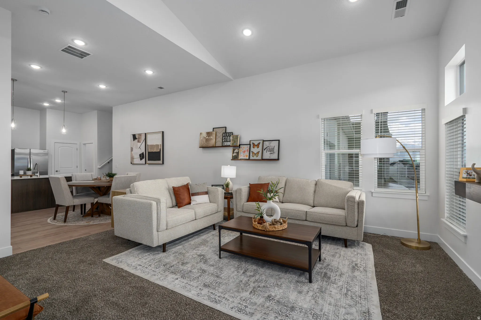 Great room with vaulted ceilings and cozy fire place opens to dining area.
