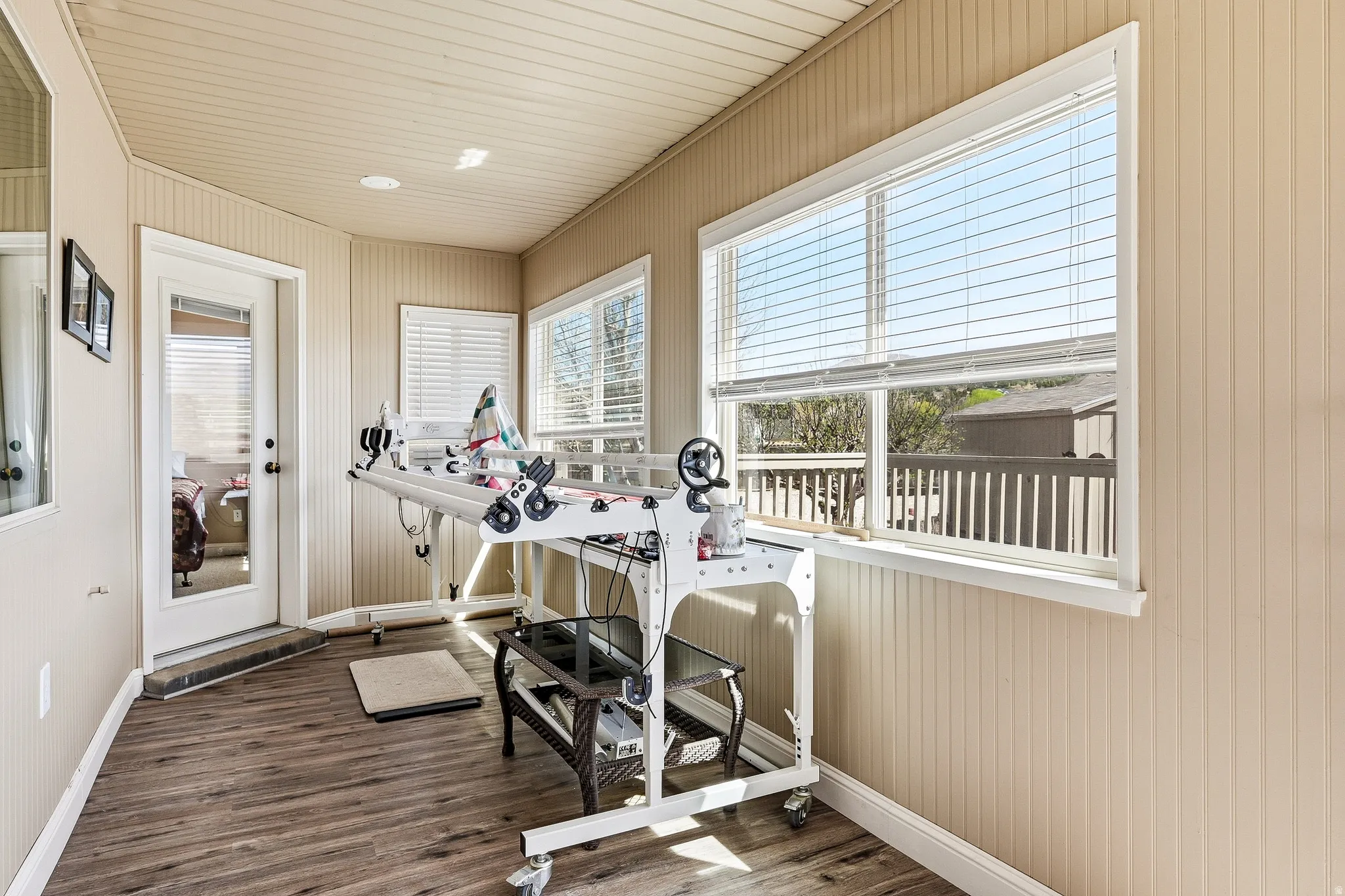 Workout area with dark wood-style floors and wood ceiling