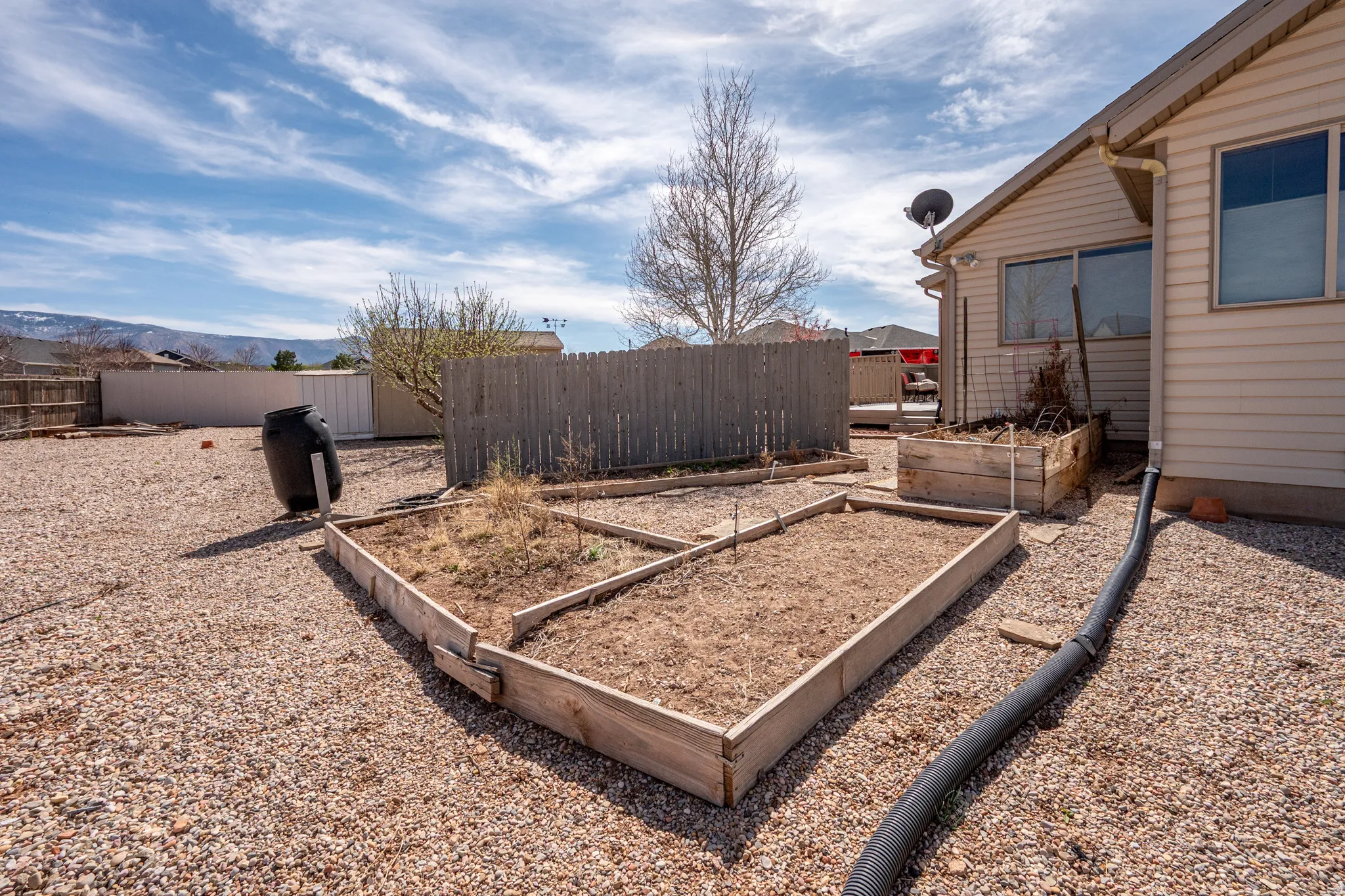 Fenced backyard featuring a mountain view
