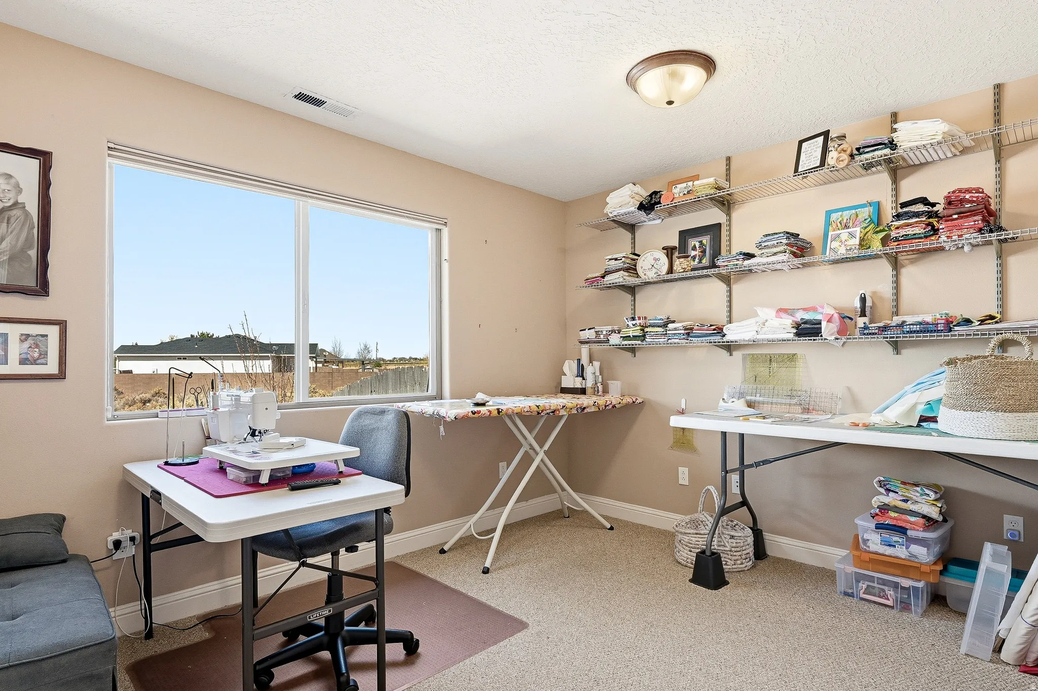 Office area with light colored carpet and baseboards