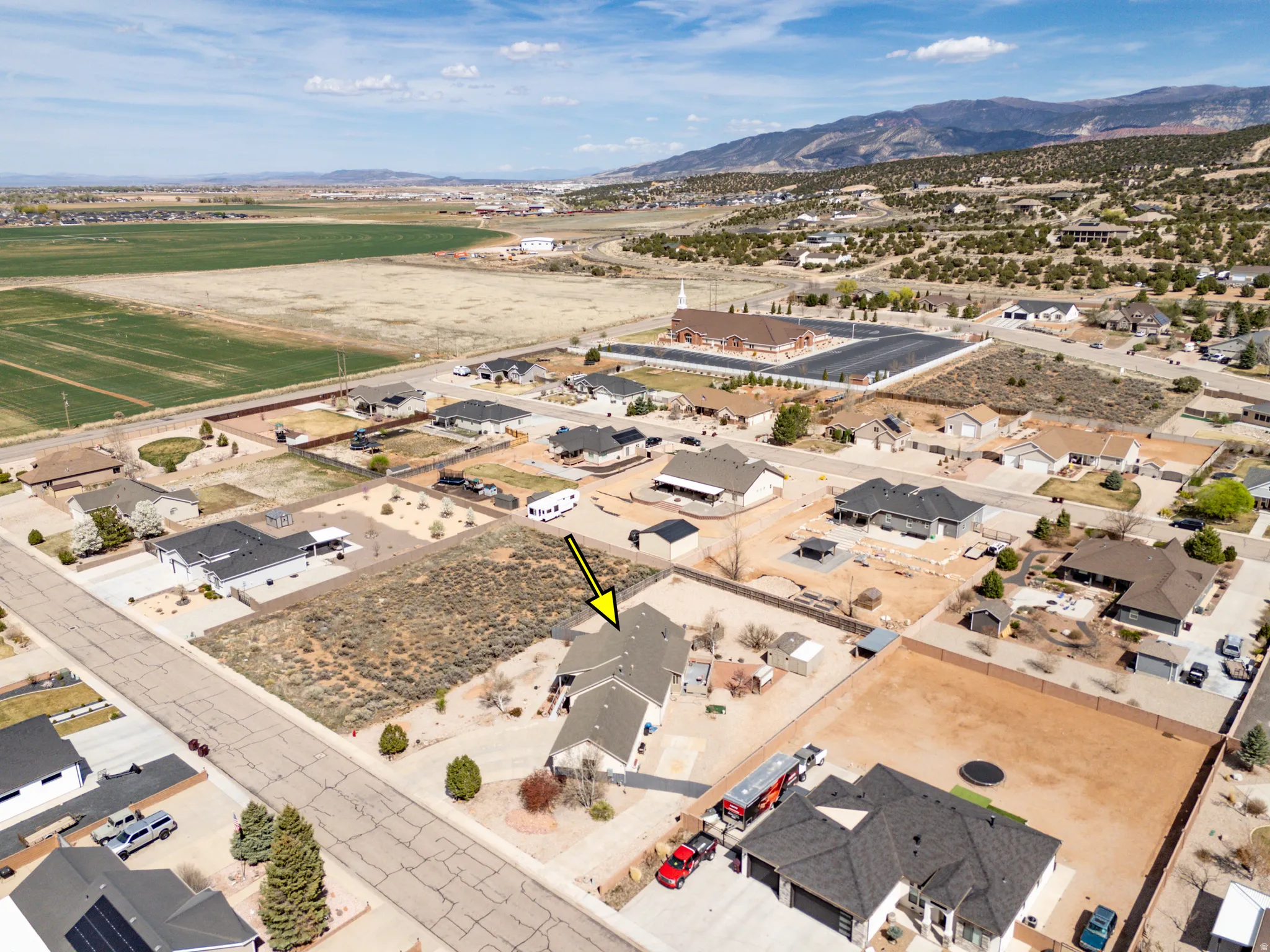 Aerial view of property's location featuring nearby suburban area and mountains