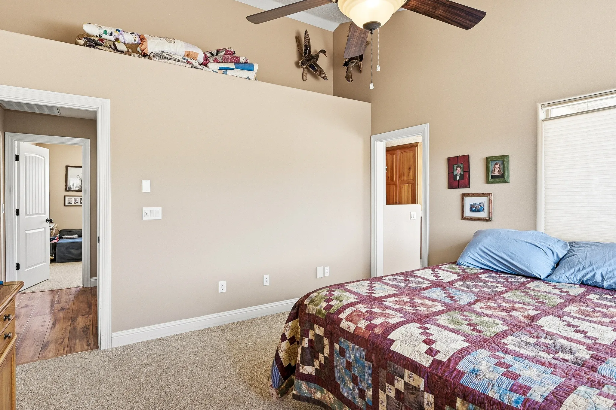 Carpeted bedroom with baseboards and a ceiling fan