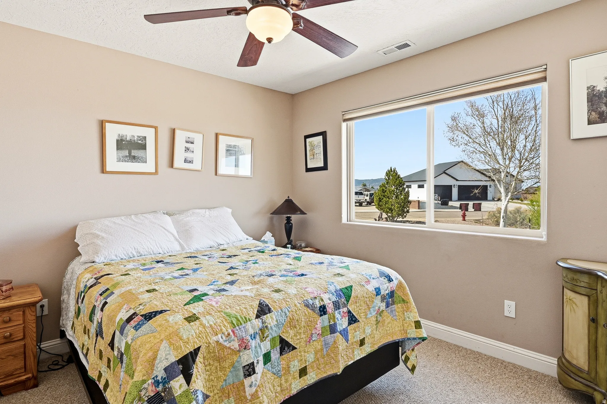 Bedroom with carpet floors and a ceiling fan